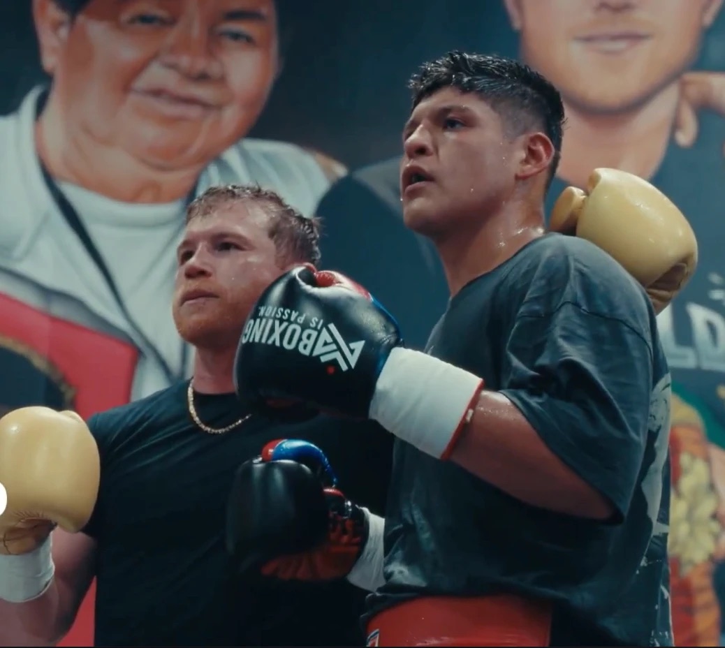 A professional fighter in training wearing black Boxing is Passion gloves